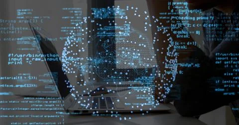 Developer wearing sweater typing code on laptop at desk, with holographic globe, 库存照片