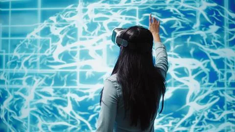 Developer wearing VR headset looking at artificial intelligence hologram 写真素材