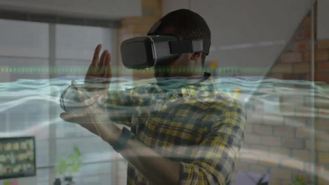 Developer wearing VR headset raising hands and analyzing tech wave data grid Stock Footage 311901049