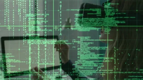 Developer wearing VR headset raising hand and manipulating floating green code Stock Footage 327006498