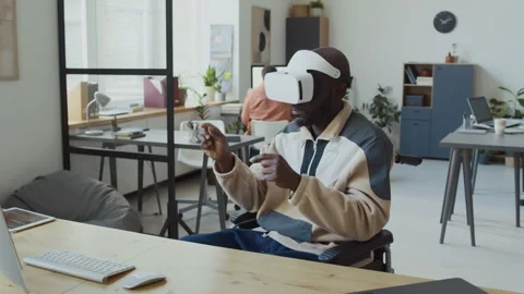 Developer in Wheelchair with VR Headset Browsing Internet in Augmented Reality 動画素材 293169108