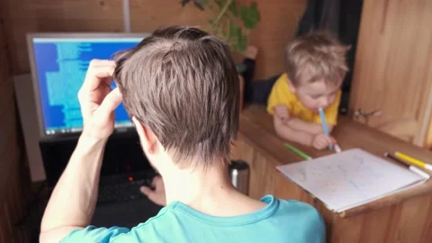 Developer work at home and helps son, small child paint, parenthood multitasking Vídeos de archivo 130495083