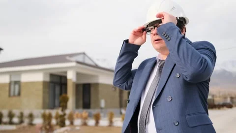 Developer worker came to inspect construction buildings and put on white helmet Stock Footage 268385325