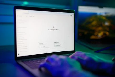 Developer working with ChatGPT AI chatbot on laptop computer screen Stock Photos