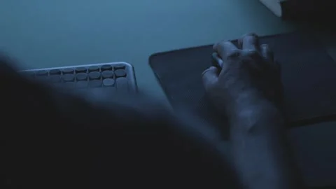Developer working on a code at night, close-up of hand on mouse 動画素材 342236854