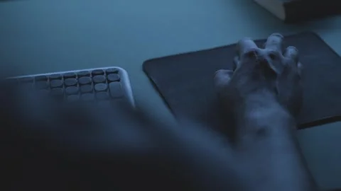Developer working on a code at night, close-up of hand on mouse 動画素材 342236926