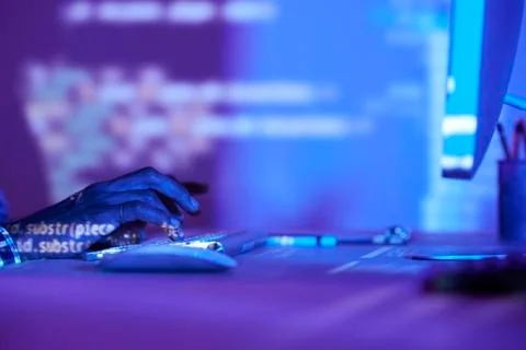 Developer working on computer in dark office 스톡 사진