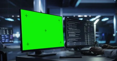 Developer Working on Computer with Green Screen Stock Footage 318967158