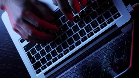 Developer working in dark office writing program code on laptop. Vertical video Stock Footage 255252017