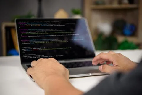 Developer working on intrusion detection system code in JavaScript with rea.. Stock Photos