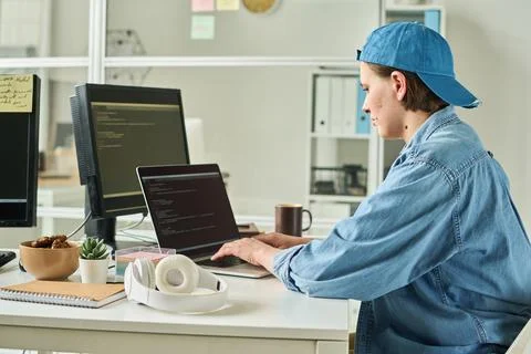 Developer working on laptop at her workplace 写真素材