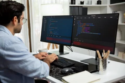Developer working software development coding two computer code screen. Surmise. Stock Photos