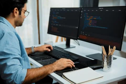 Developer working software development coding two computer code screen. Surmise. 写真素材