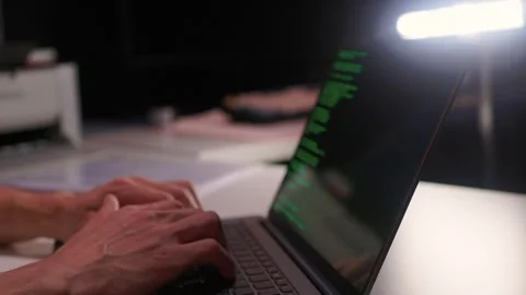 Developer working under dim light. Night coding session with glowing screen and Stock Footage 346244786
