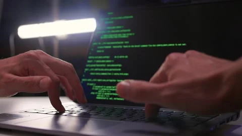 Developer working under dim light. Night coding session with glowing screen and Stock Footage 346244789