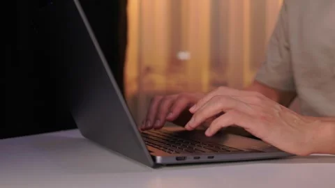 Developer working under dim light. Night coding session with glowing screen and Stock Footage 346244798