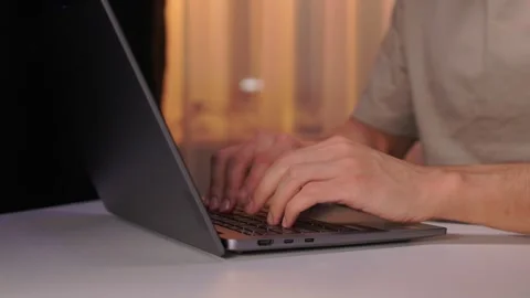 Developer working under dim light. Night coding session with glowing screen and Stock Footage 346244806