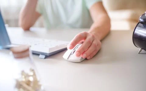 The developer works at the computer, typing, uses the mouse. Selective focus Stock Photos