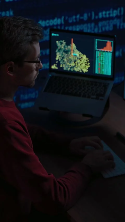 Developer works late on a machine learning or AI project Video stock 345446303
