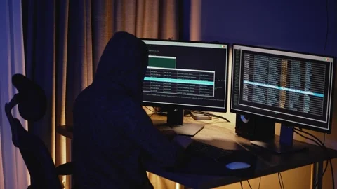 Developer works late at night in low light, focused on code and system security. Stock Footage 323462612