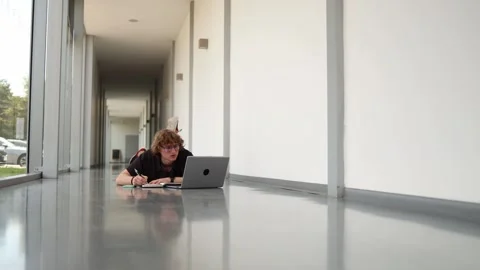 Developer works lying on the floor Stock Footage 338277252