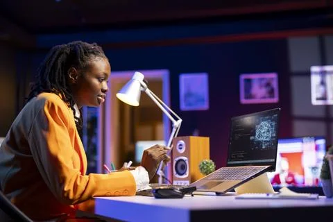 Developer writing artificial intelligence code on laptop in home office Stock Photos