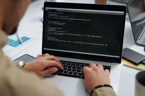 Developer writing codes on computer Stockfoto's