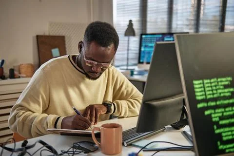 Developer Writing down Plans for the Day Stock Photos