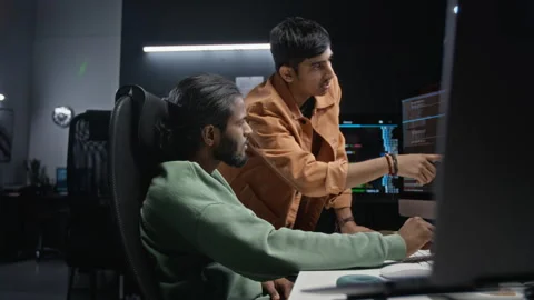 Developers Analyzing Code on Computer Monitor in it Office Stockbeeldmateriaal 348370759