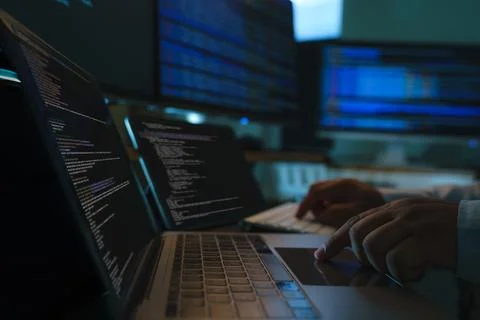 Developers coding a new application project at a multi screen workstation w.. Stock-Fotos