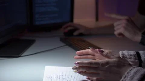 Developers collaborate on code changes. Team members analyze notes and discuss Stock Photos