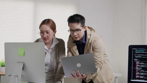 Developers Collaborating on Software Code in Modern Office Video stock 343621412