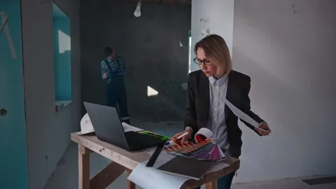 The developer's company specialists work at the construction site. A woman Video stock 269949941