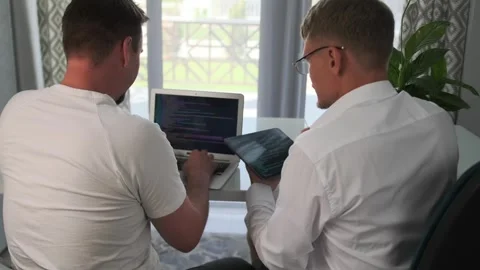 Developers discuss functionality and adjusts the code. Stock Footage 294298917