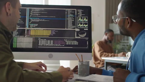 Developers Discussing Programming Code on Computer Screen Stock Footage 277414133