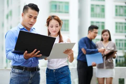 Developers discussing programming code Stock Photos