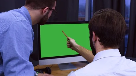 Developers discussing project on a computer screen 스톡 동영상 70972875