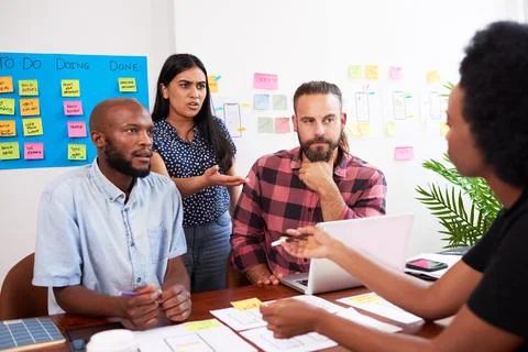 Developers have heated discussion while planning new app, tech start up meeting Stock-Fotos