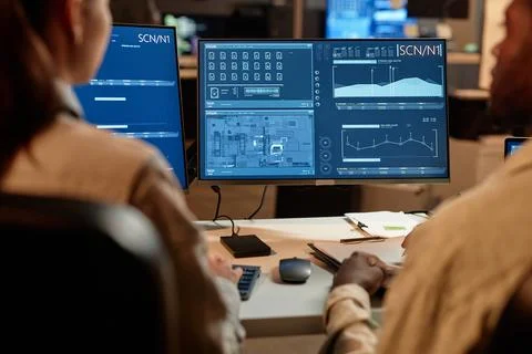 Developers looking at data charts Stock Photos