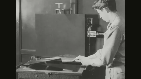 Developers place the roll of negative inside the printer - 1940 Stock Footage 107698550