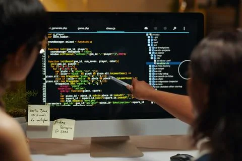 Developers Pointing at Programming Code Foto stock