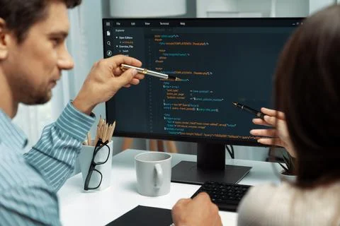 Developers program coding discussing website planning software. Postulate. 库存照片