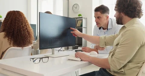 Developers reviewing code at workstation, collaborative software team in office Stock Footage 337560814