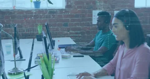 Developers starting typing at shared desk creating live code overlays improving Stock Footage 329989770