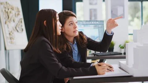Developers trying to design blueprints for new construction site Foto stock