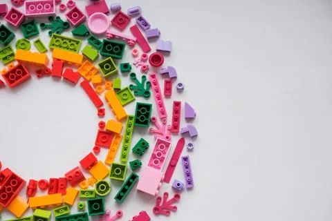 Developing children games frame. Colorful plastic bricks and blocks on white Stock Photos