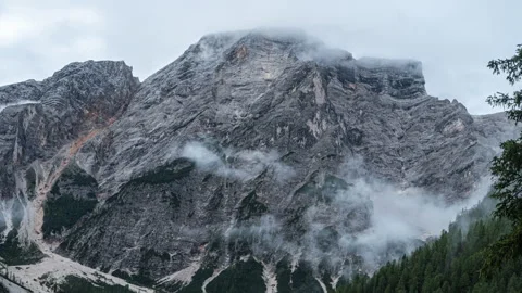Developing clouds moving around rugged Dolomites extreme rocky mountain Video stock 263888767