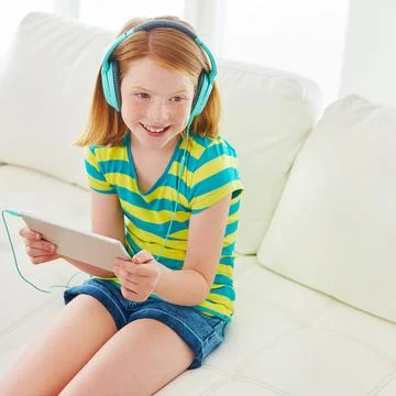 Developing her mind in the digital age. a little girl using a digital tablet Stock Photos