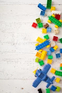 Developing multi-colored cubes on a white wooden table. Plastic construction  Stock Photos