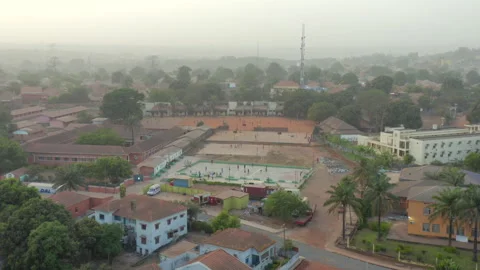 Developing Nation Urban Landscape, Red Roofs and Dusty Terrain in Guinea Bissau Stock Footage 323179966
